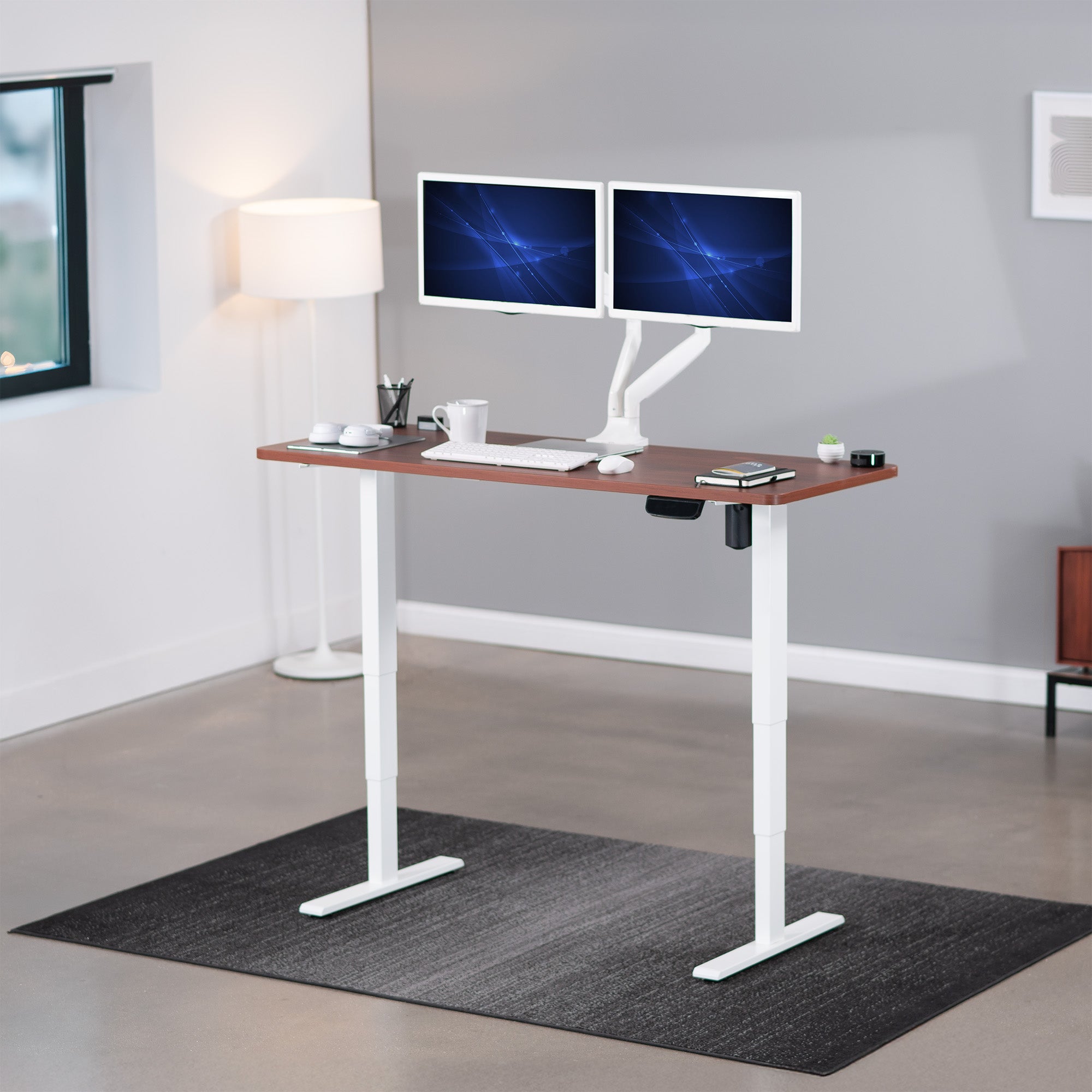 Heavy-duty electric height adjustable desktop workstation for active sit or stand efficient workspace.