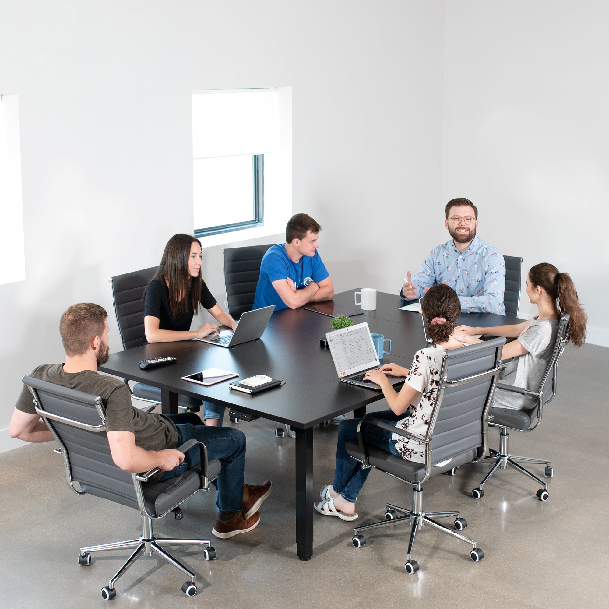 Dual Motor Electric 4-Leg Desk with Square Corner Top provides a spacious workstation for a conference room or project table and creates smooth height adjustment at the push of a button.