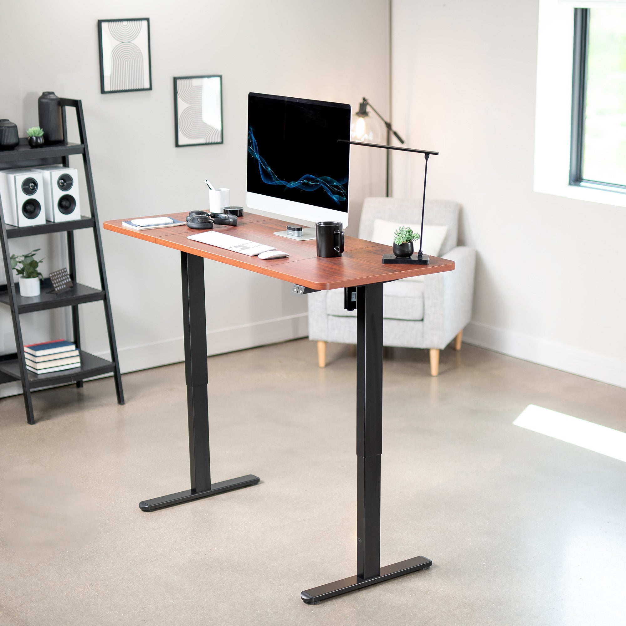 Modern office setup with a standing desk, computer monitor, and office furniture.