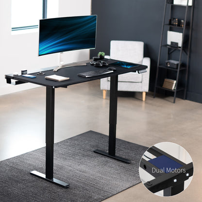 Dual motor electric desk with concealed cable management/storage trays and a full-sized desk pad, featuring memory controller height adjustment with memory settings.