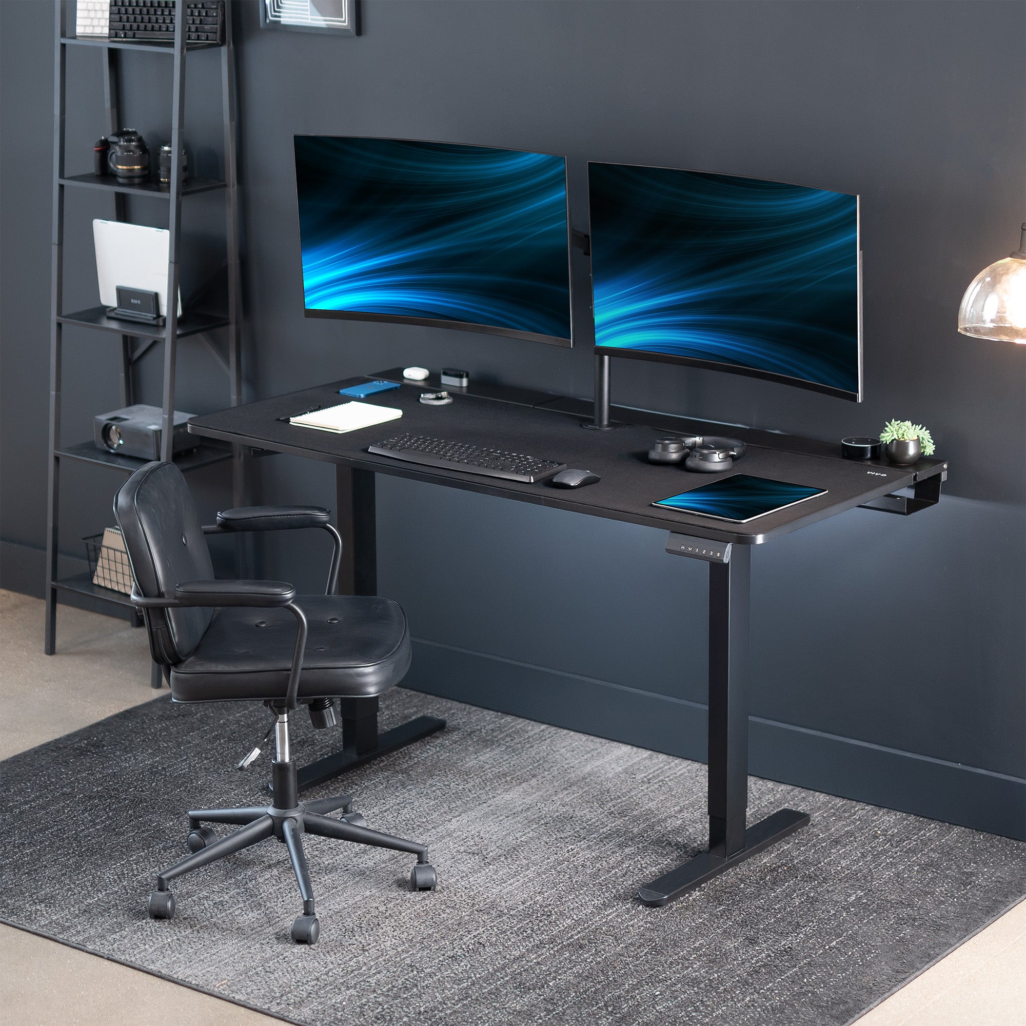 Dual motor electric desk with concealed cable management/storage trays and a full-sized desk pad, featuring memory controller height adjustment with memory settings.