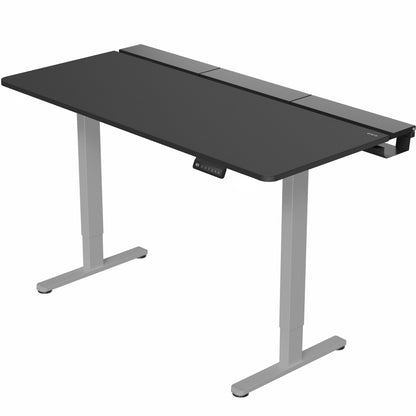 Dual motor electric desk with concealed cable management/storage trays and a full-sized desk pad, featuring memory controller height adjustment with memory settings.