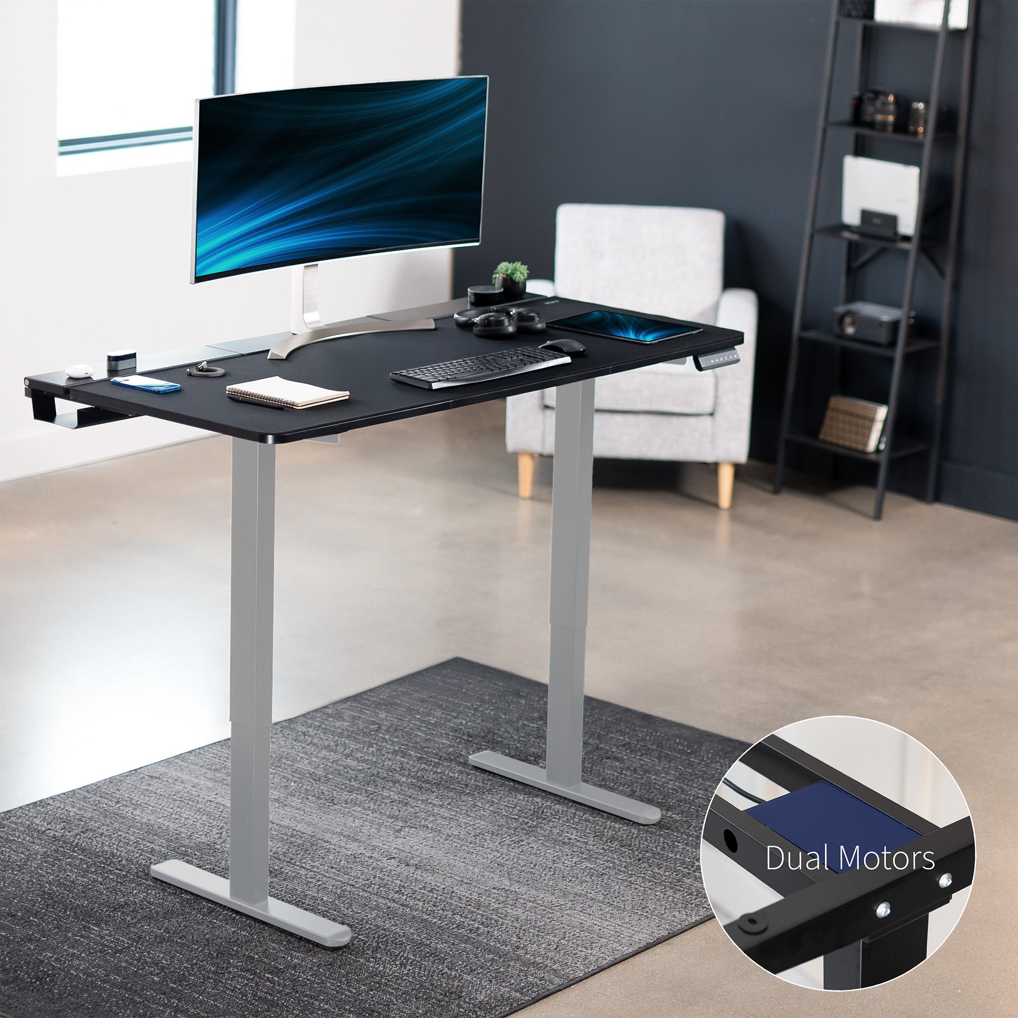 Dual motor electric desk with concealed cable management/storage trays and a full-sized desk pad, featuring memory controller height adjustment with memory settings.