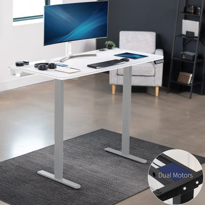 Dual motor electric desk with concealed cable management/storage trays and a full-sized desk pad, featuring memory controller height adjustment with memory settings.