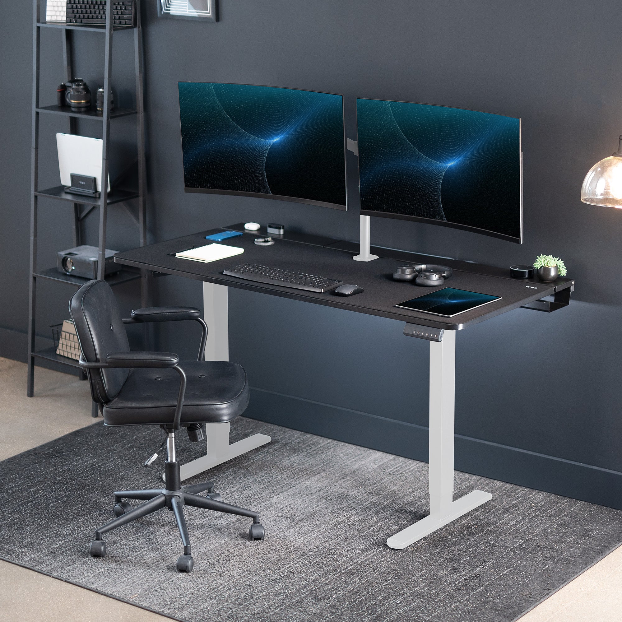 Dual motor electric desk with concealed cable management/storage trays and a full-sized desk pad, featuring memory controller height adjustment with memory settings.