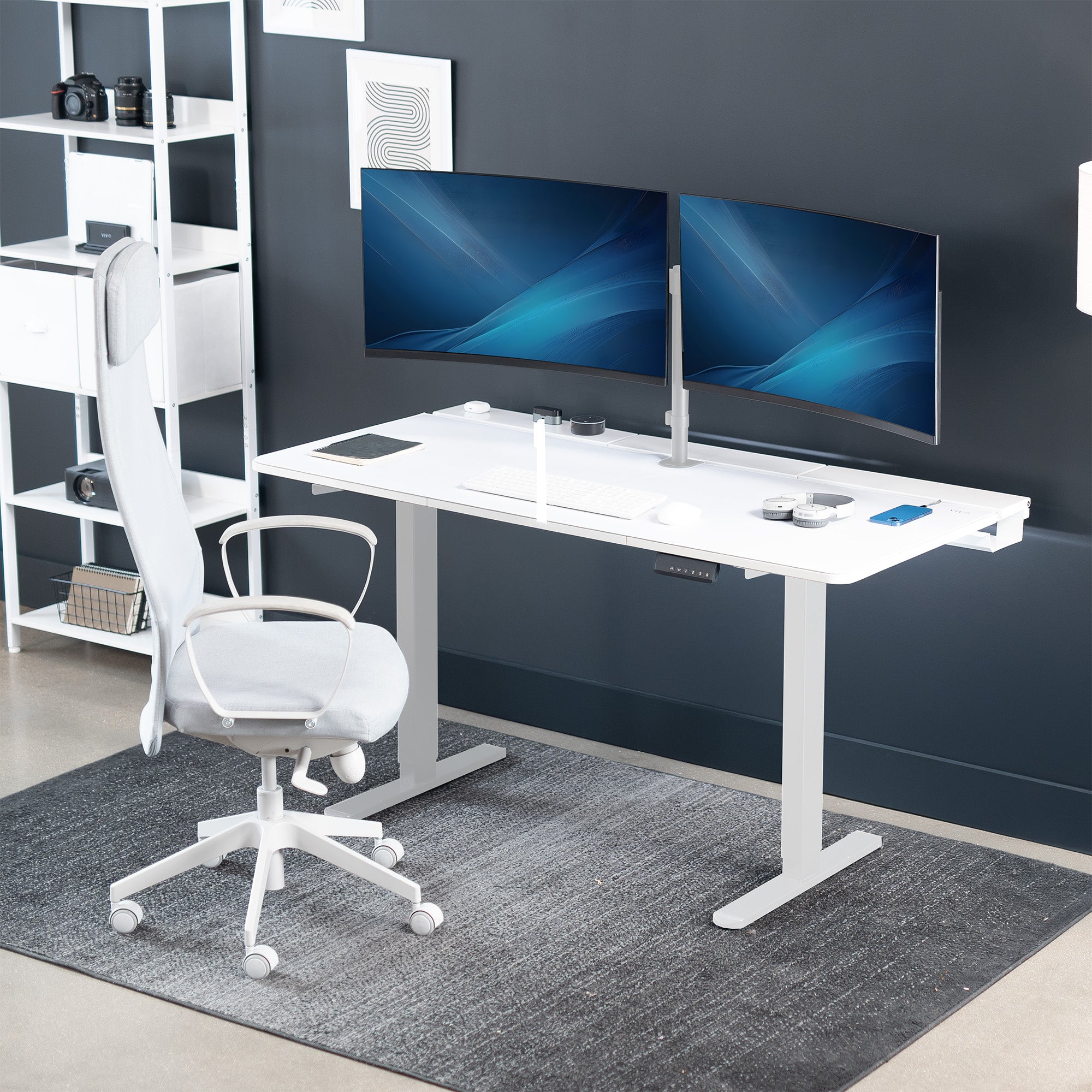 Dual motor electric desk with concealed cable management/storage trays and a full-sized desk pad, featuring memory controller height adjustment with memory settings.