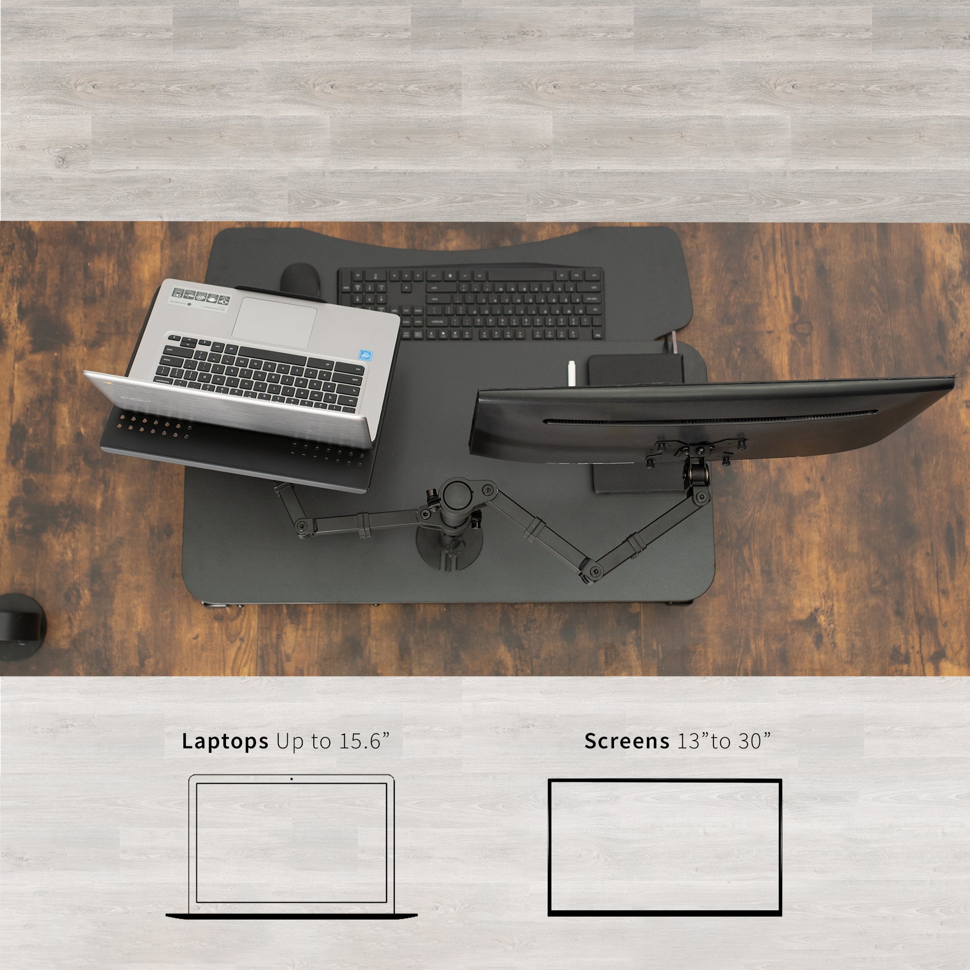 Sit to stand desk riser with built-in monitor mount and laptop mount.