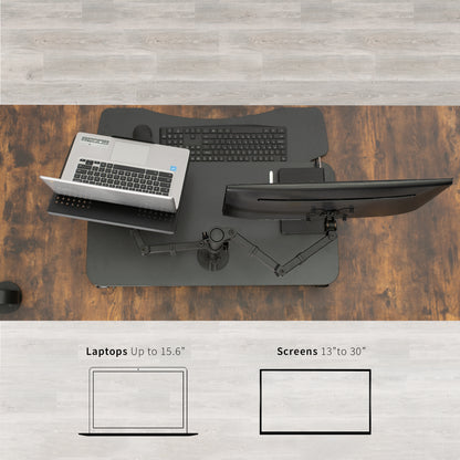 Sit to stand desk riser with built-in monitor mount and laptop mount.