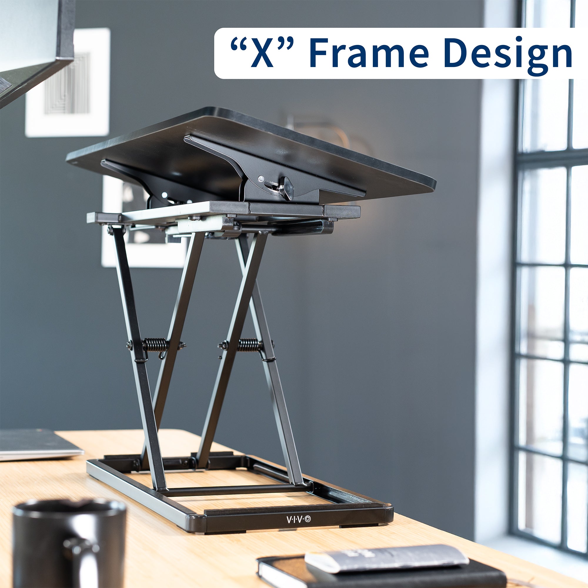 A black tilting keyboard riser with an "X-frame" design. 