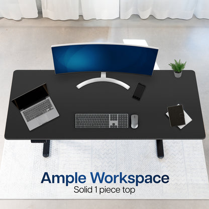 Black desk with computer setup including a monitor, laptop, keyboard, and mouse on a white floor.