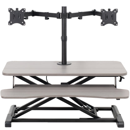 Sturdy height adjustable desk converter with articulating dual monitor mount.