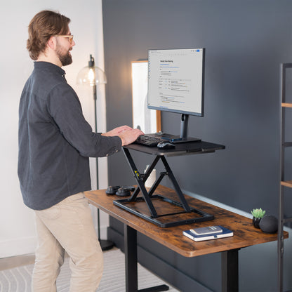 Heavy-duty height adjustable desk converter monitor riser.