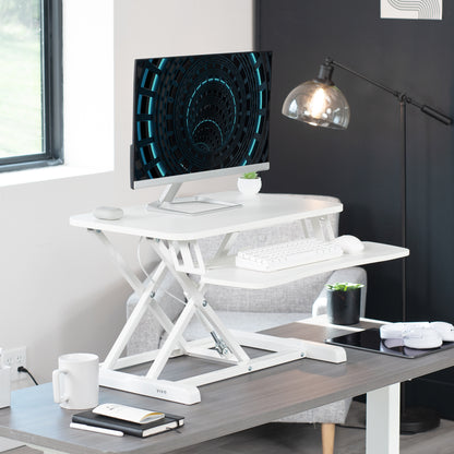 Sturdy height adjustable 2-tiered desk riser for ergonomic office workstation.