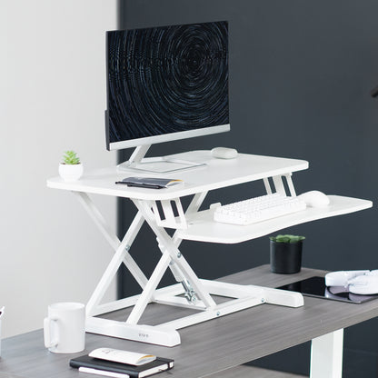 Sturdy height adjustable 2-tiered desk riser for ergonomic office workstation.