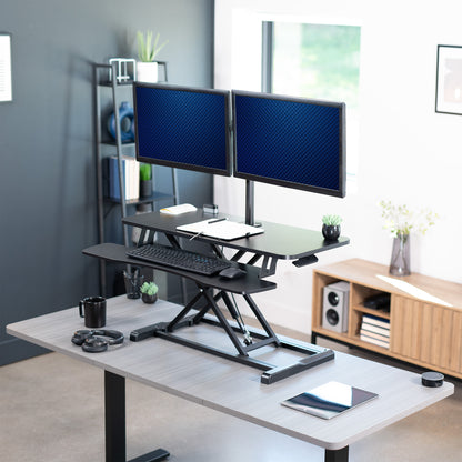 Sturdy height adjustable desk converter with articulating dual monitor mount.