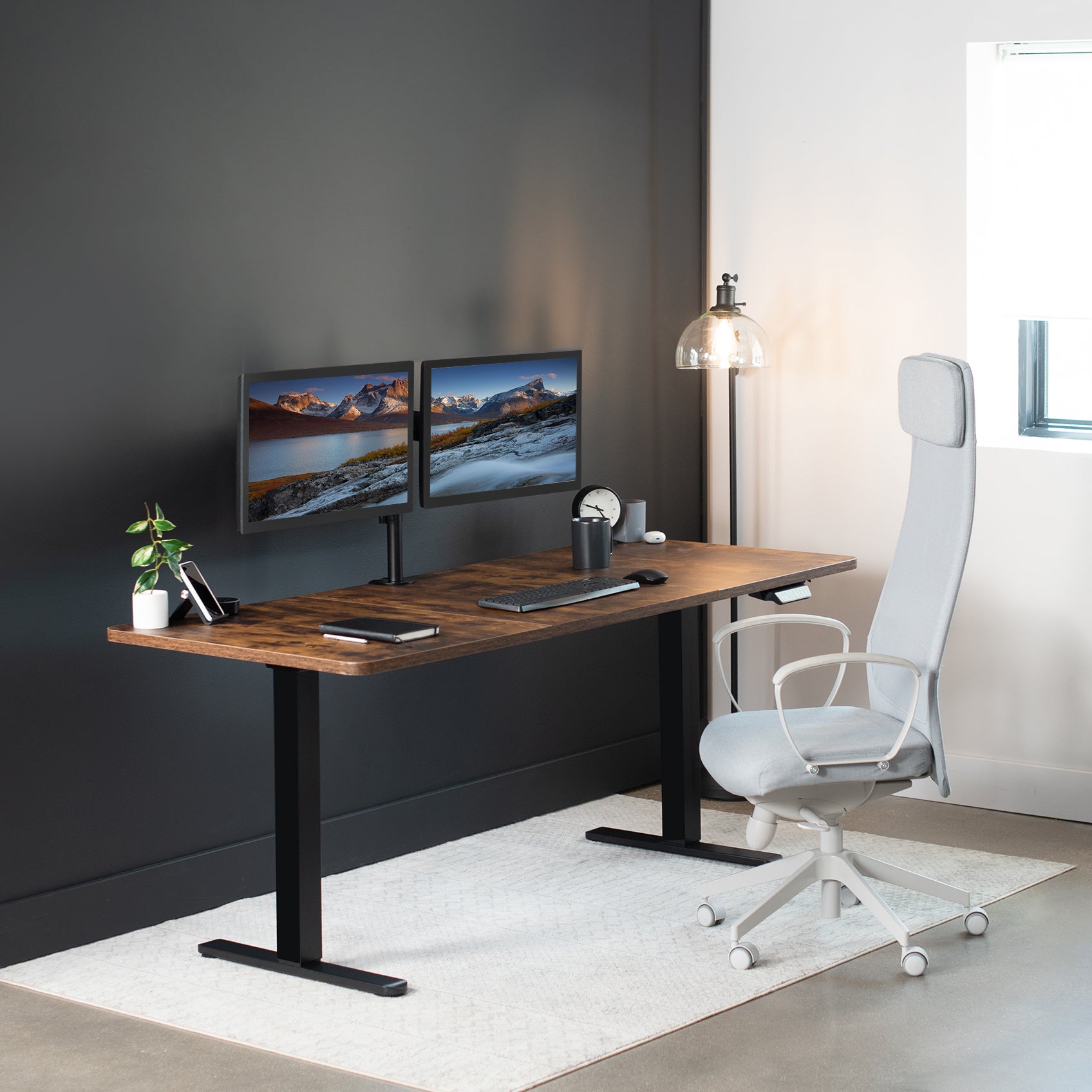 Electric dual motor desk frame in sitting position in home office. 
