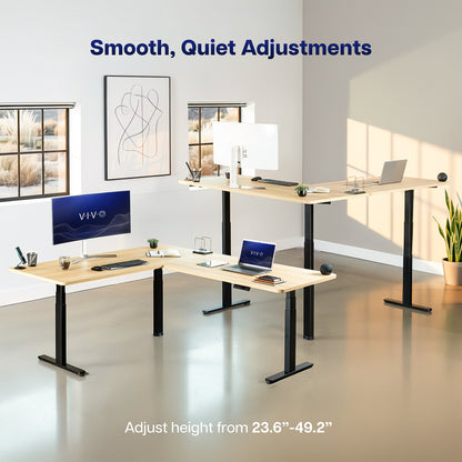 An L-shaped standing desk setup in a bright modern office, showing two adjustable height standing desks with light wood tops and black metal legs. The image includes text overlays reading 'Smooth, Quiet Adjustments' and 'Adjust height from 23.