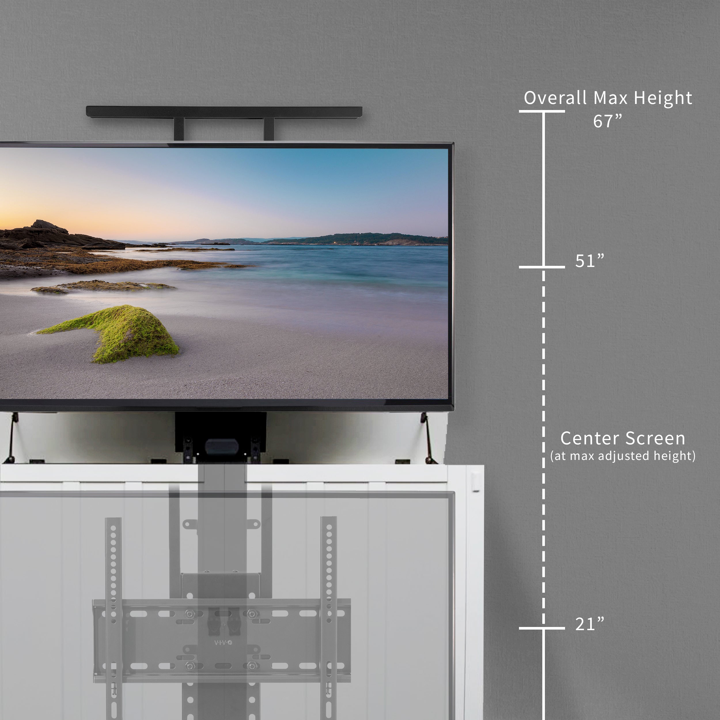 A motorized TV stand with dimensions on a gray wall. 