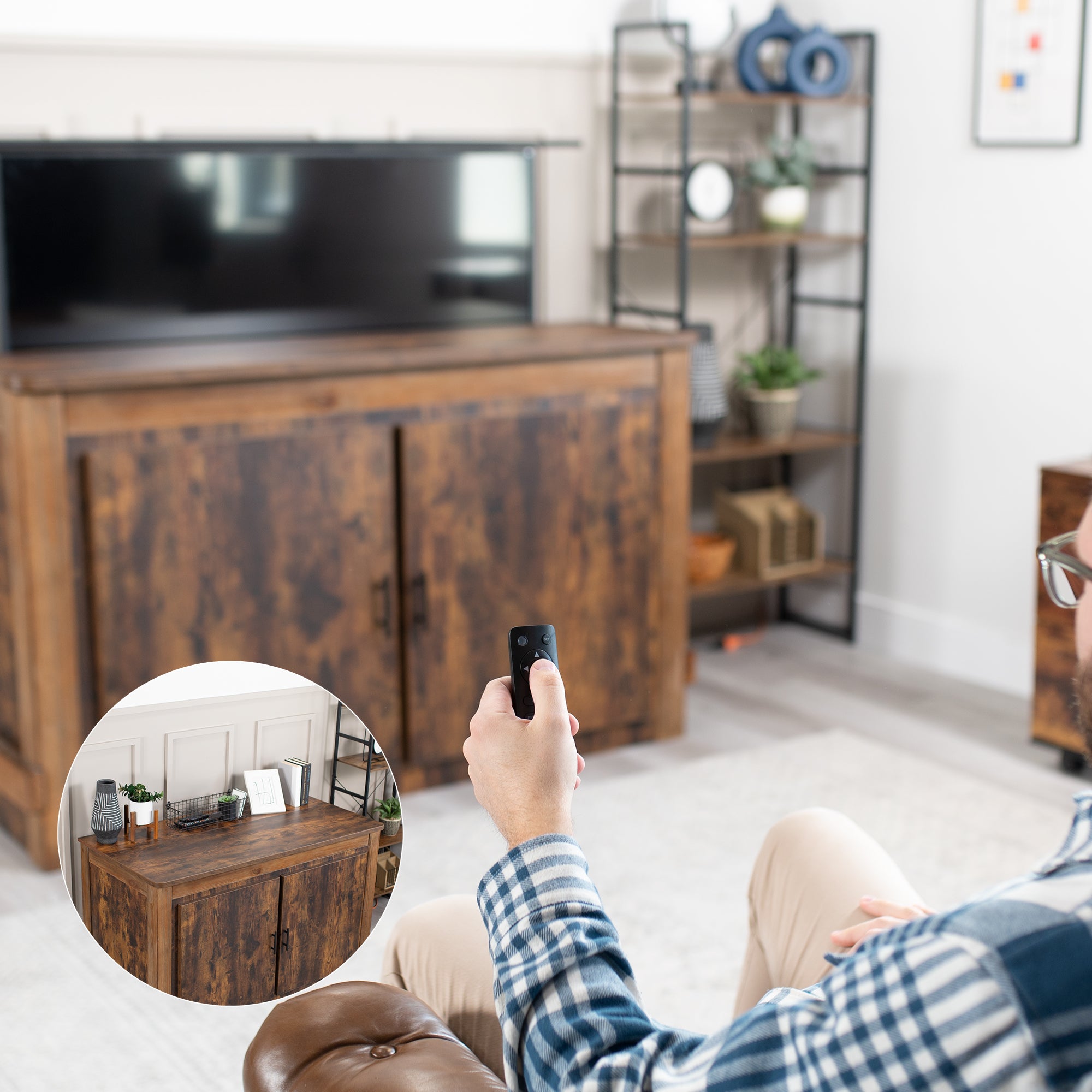 A motorized TV stand in black color with a remote control in a living room scene. 