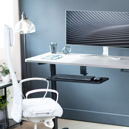 Low-profile under desk keyboard tray with 360-degree rotation.