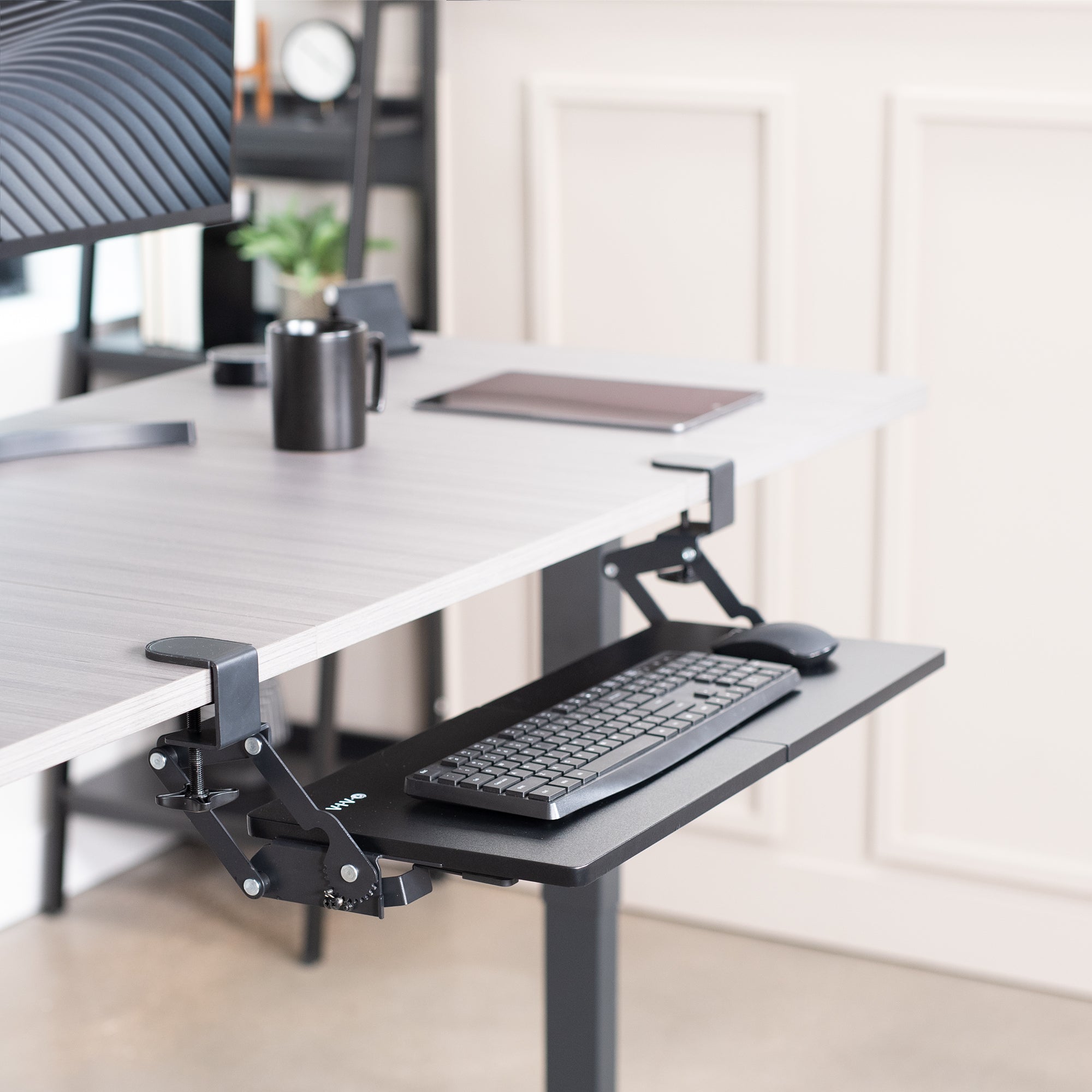 Ergonomic convenient under desk clamp-on keyboard tray with swinging height adjustment.