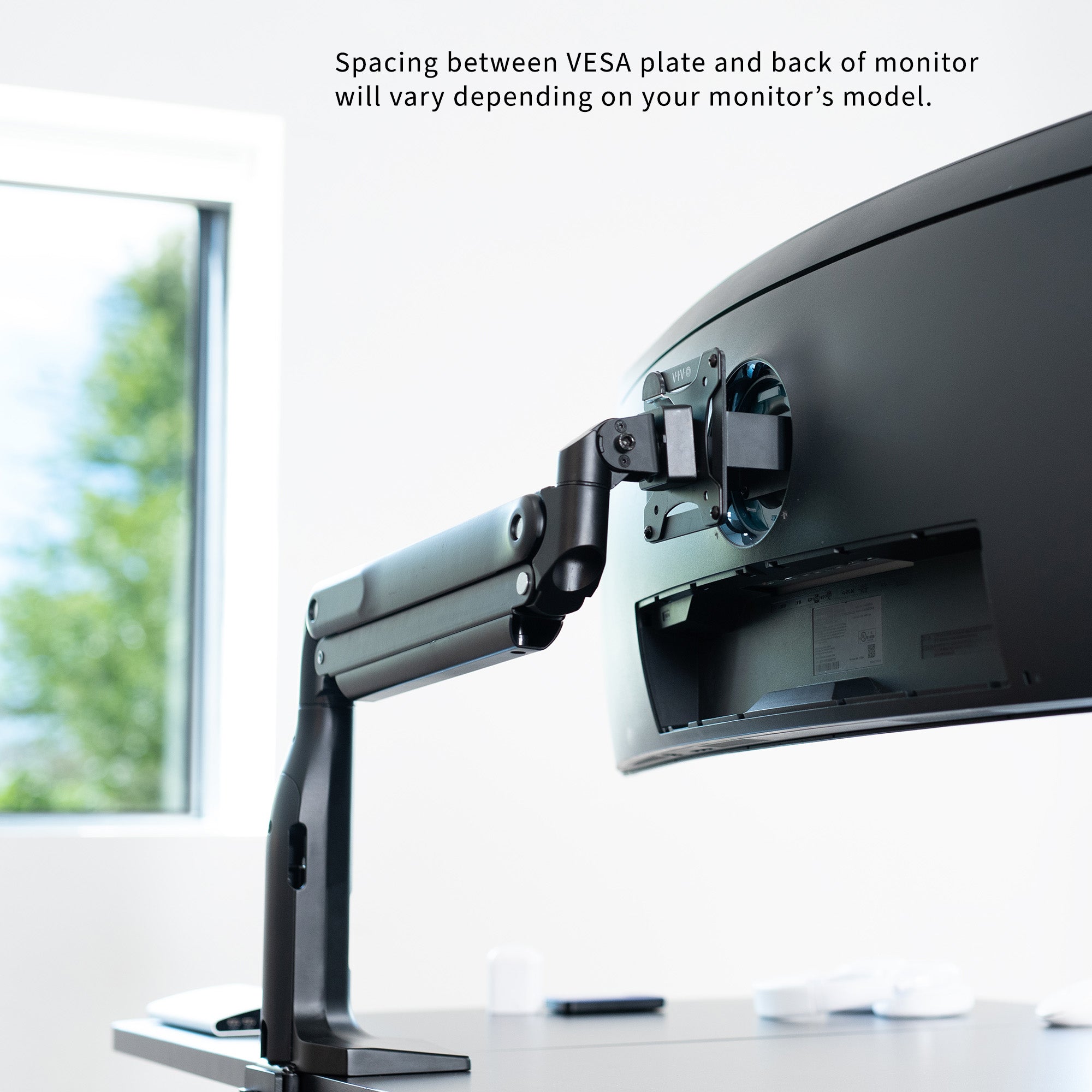 Spacing between VESA plate and back of monitor will vary depending on your monitor's model