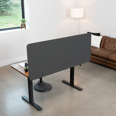 Clamp-on desk privacy panel for office workspace.