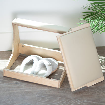 A birch wood footrest with a white cushion on top and storage compartment beneath.