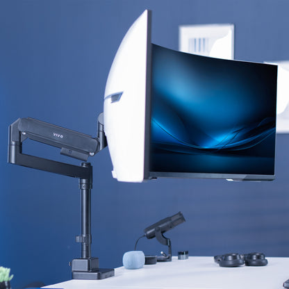 Single ultrawide monitor mounted on a pneumatic arm desk mount. 