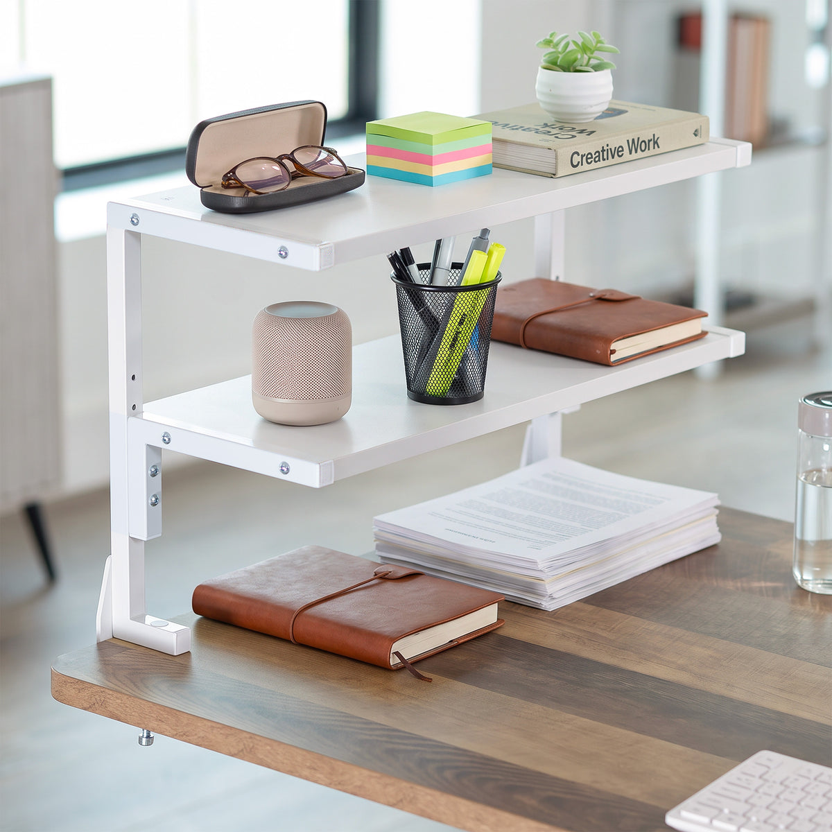 White wide spacious above desk or below desk clamp-on shelf with two shelves for convenient storage and organization. Lower shelf height adjusts.