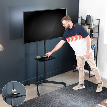 Mobile TV cart displays large screen on rolling stand for ergonomic viewing.