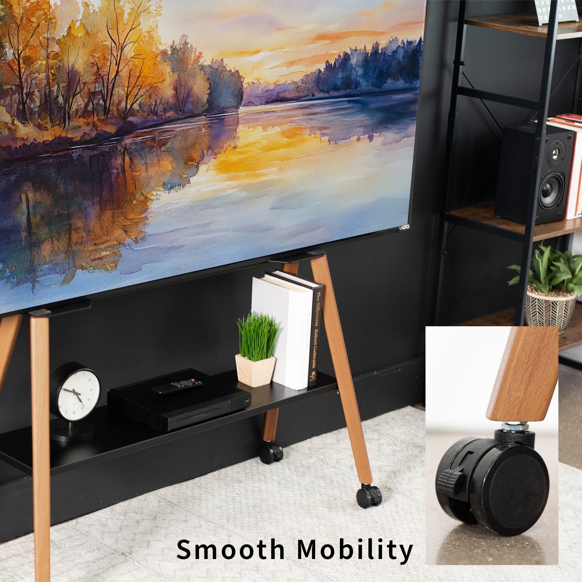 Black/Walnut TV stand with wooden legs displaying a scenic painting like scene, books, and decorative items.