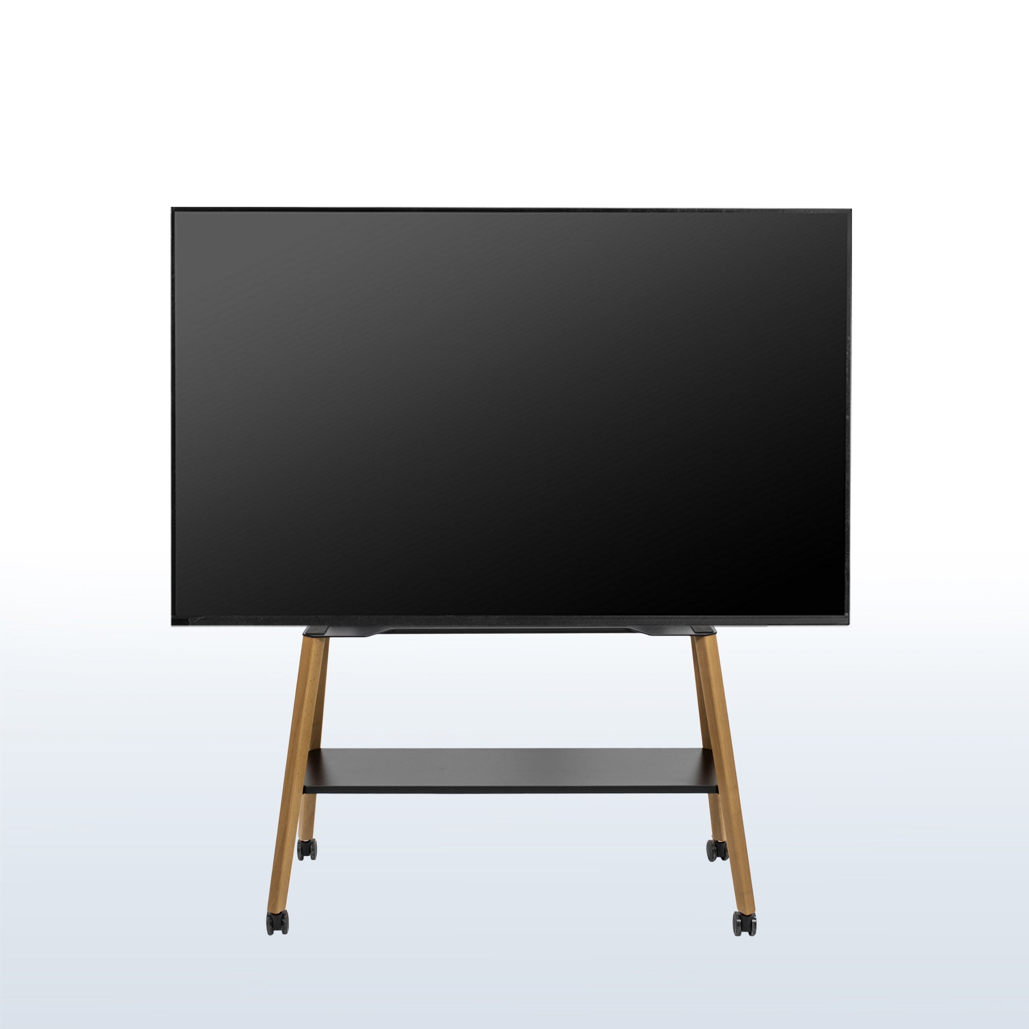 A large flat-screen display monitor on a wheeled easel TV stand with a black screen, slim black frame, and light wood legs, shown against a light gray gradient background.