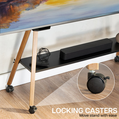 A TV stand with a black shelf, light wood legs, and black locking casters, shown in a room setting with a TV and accessories on the shelf. A circular inset highlights the locking caster mechanism.