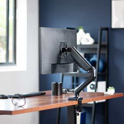 Sturdy clamp-on pneumatic arm single monitor desk mount with articulation, height adjustment, and cable management.