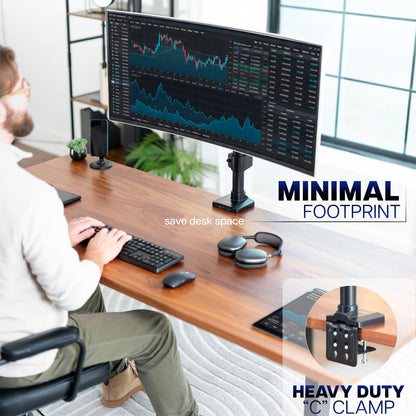 Person working at a desk with a large monitor, keyboard, and mouse, featuring text about minimal footprint and heavy duty clamp.
