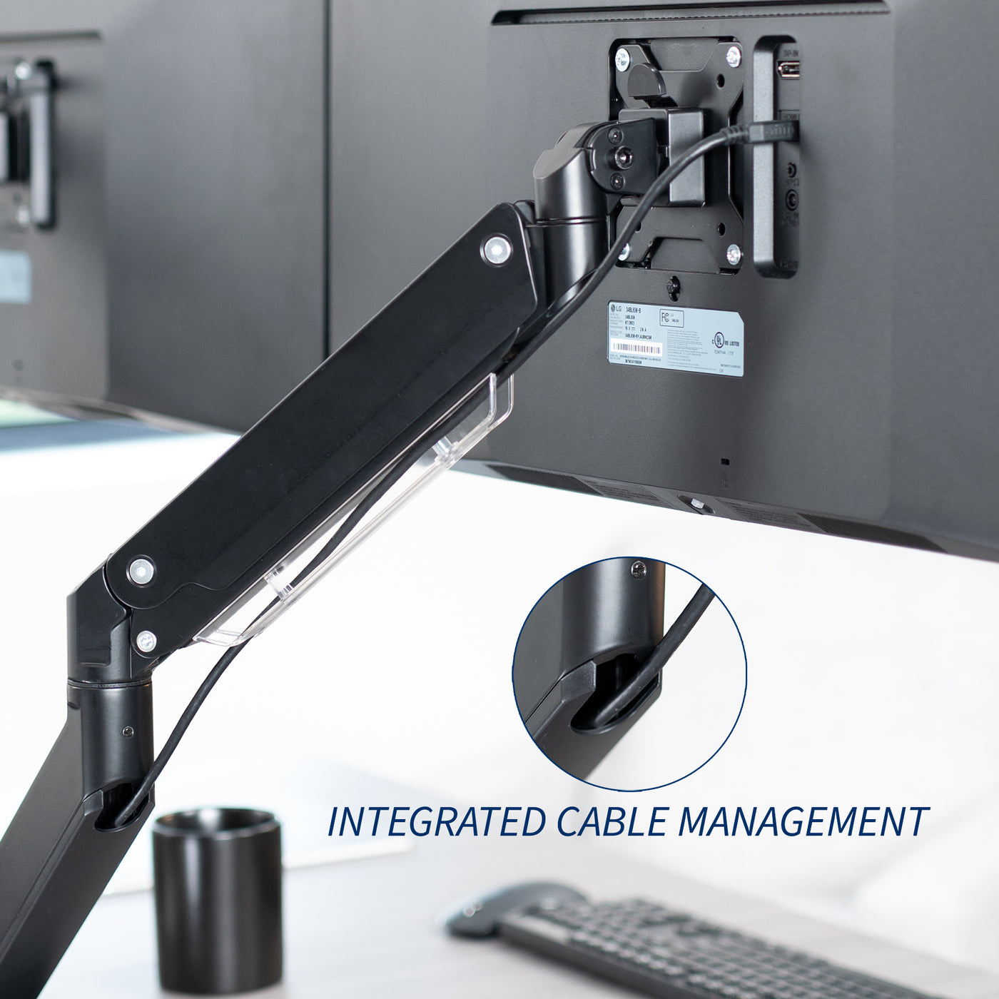 Adjustable pneumatic dual monitor desk mount with USB ports for ultrawide monitors with integrated cable management.