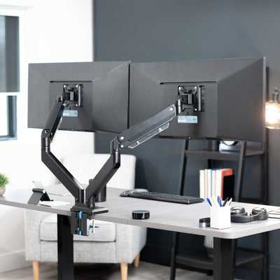 Adjustable pneumatic dual monitor desk mount with USB ports for ultrawide monitors.