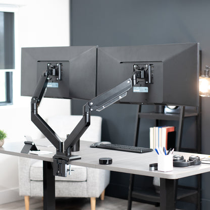 Adjustable pneumatic dual monitor desk mount for ultrawide monitors.