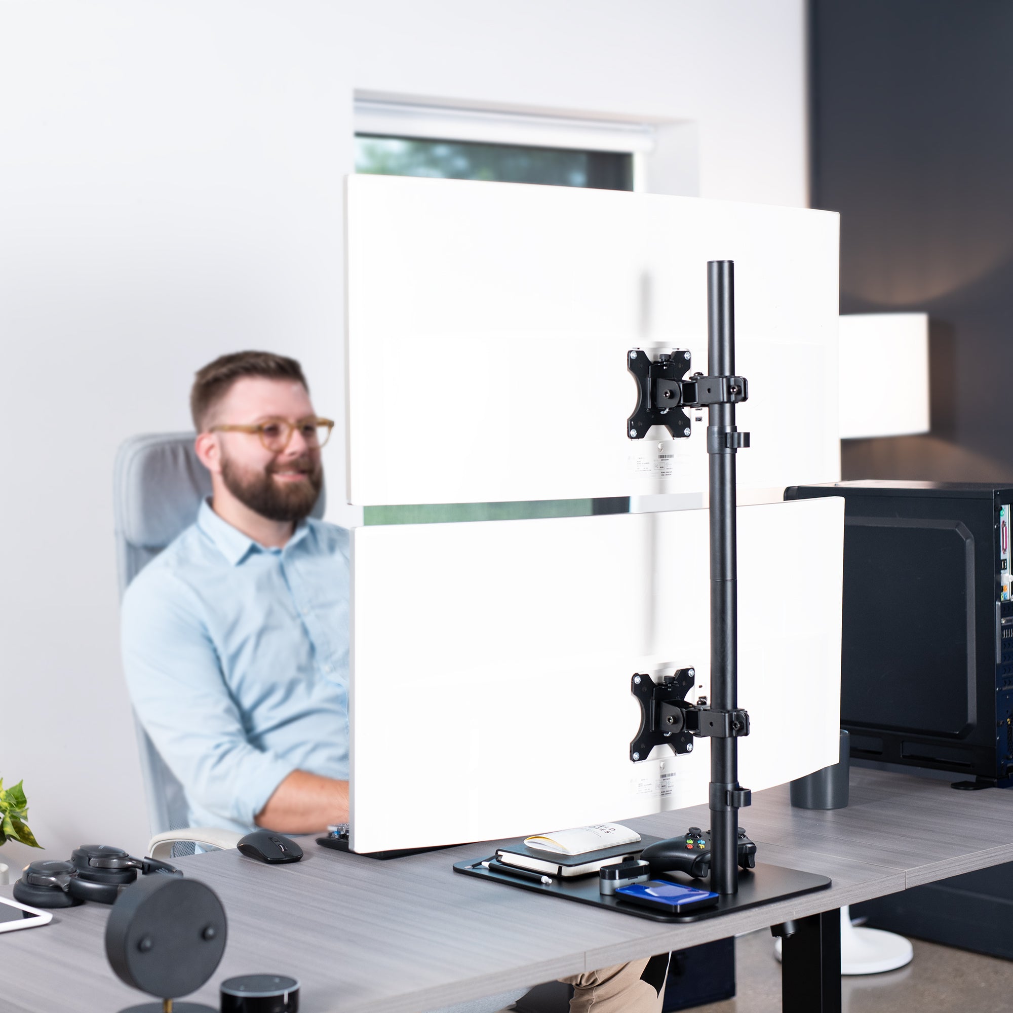 Dual Ultrawide Vertical Monitor Desk Stand elevates 2 large monitors in a vertically stacked array for comfortable viewing angles and efficient use of desk space. The freestanding base provides excellent support with no need to drill or clamp into your desktop.