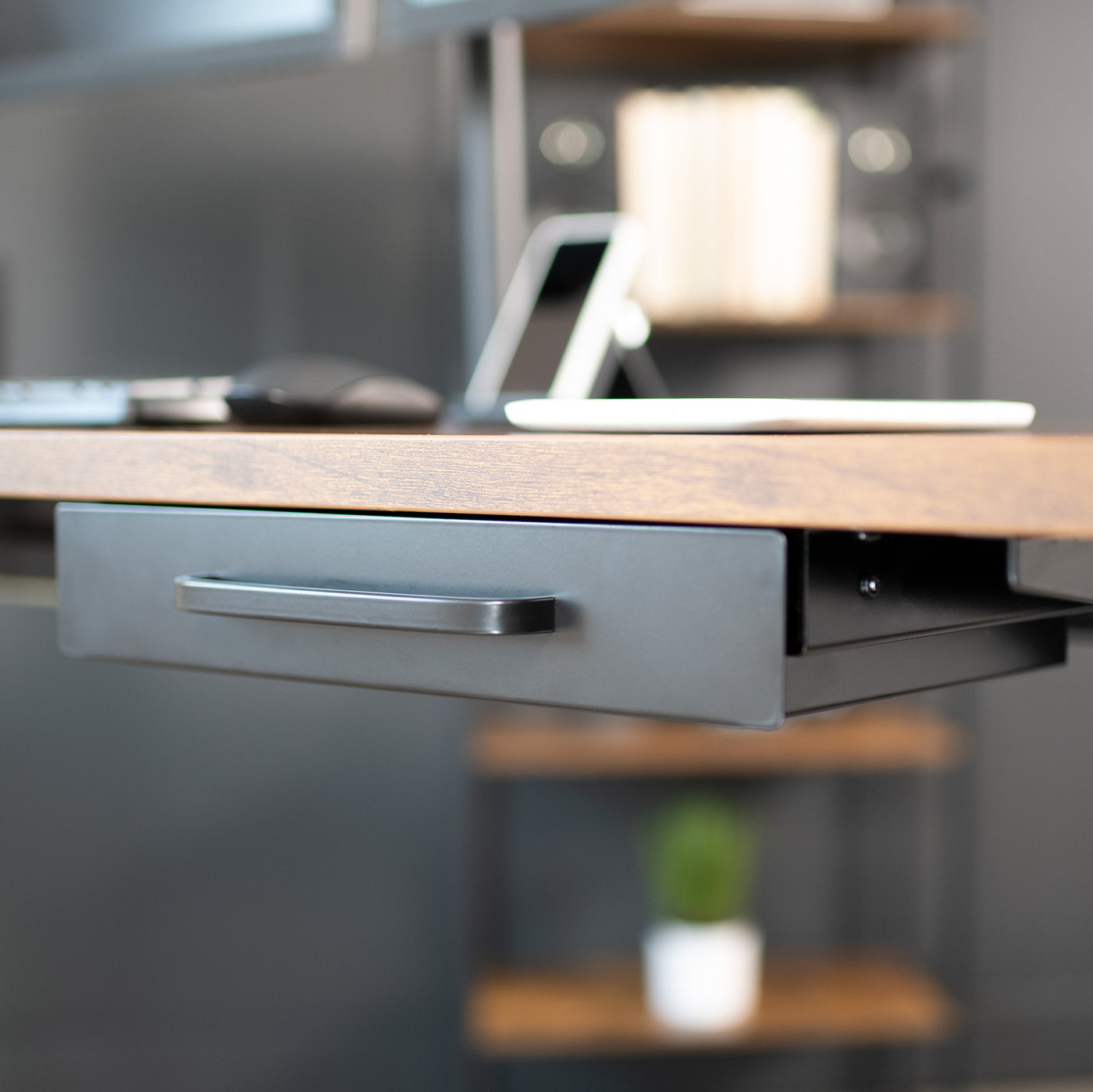 This 13.3” (14.8” including side brackets)  x 8.7” x 2.5” pull-out drawer mounts to the underside of your desk (at least 0.75” thick) and provides extra storage space for decluttering your area in style. Designed to fit both standing desks and standard fixed-height workstations.