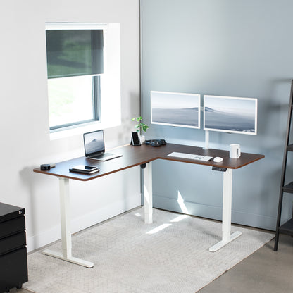 Electric heavy-duty corner desk workstation for modern office workspaces. 