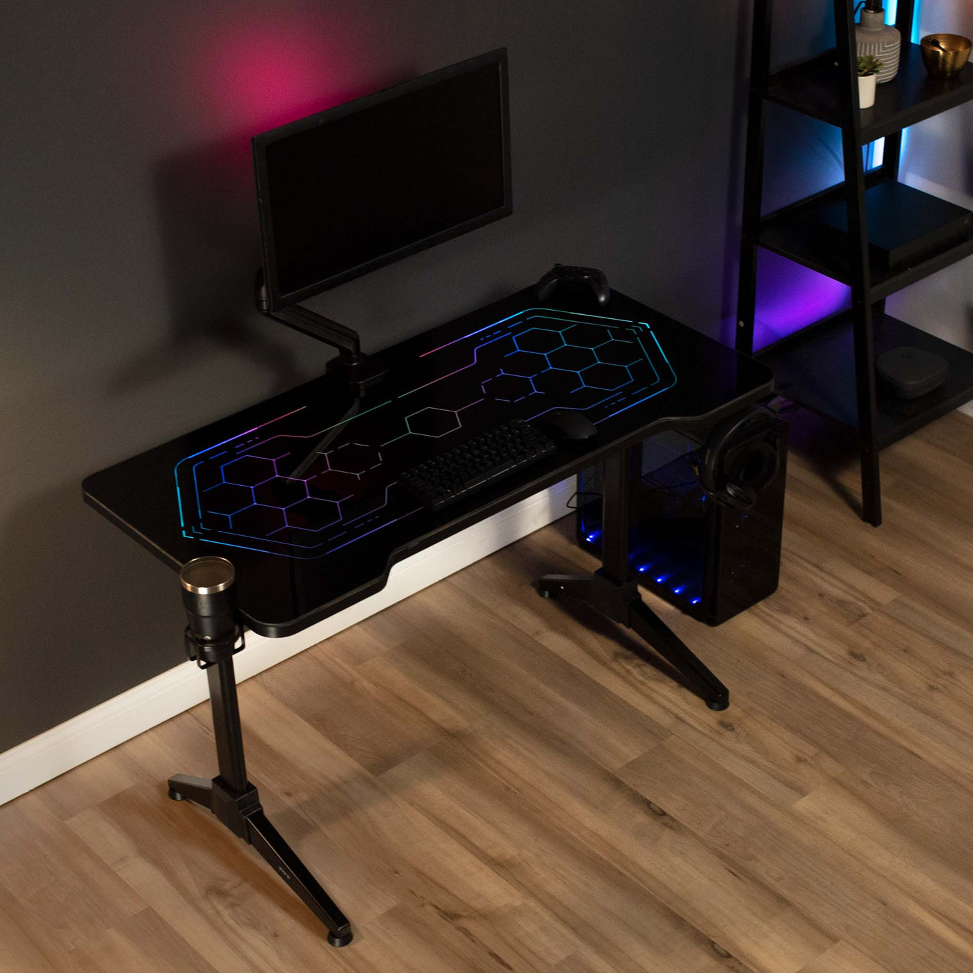 Sturdy RGB lighting gaming desk with color changing remote controlled LED lights under tempered glass tabletop surface.