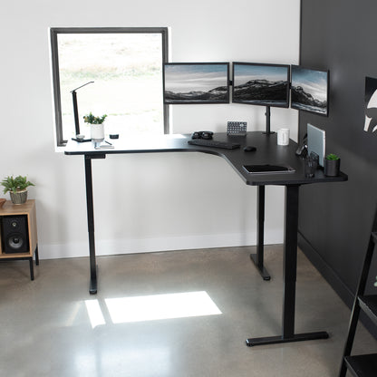 Large heavy-duty electric height adjustable corner desk workstation with programmable memory controller.