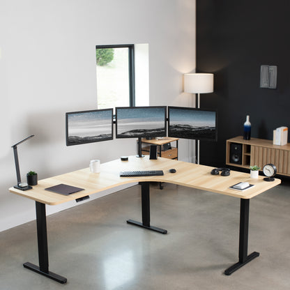 Large heavy-duty electric height adjustable corner desk workstation with programmable memory controller.