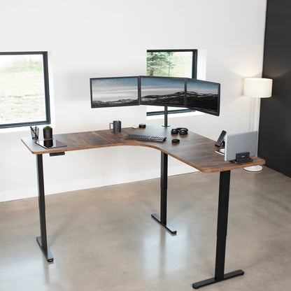 Large, rustic, heavy-duty electric height adjustable corner desk workstation with programmable memory controller.