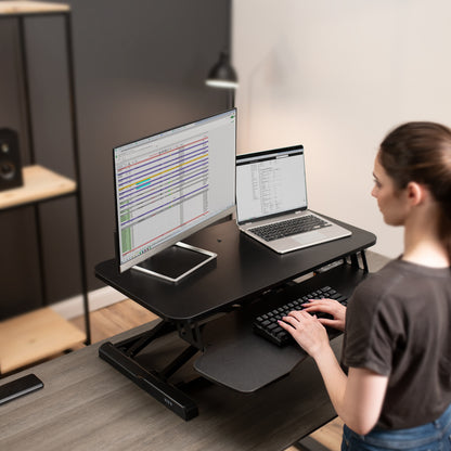 Sturdy height adjustable 2-tiered desk riser for ergonomic office workstation.