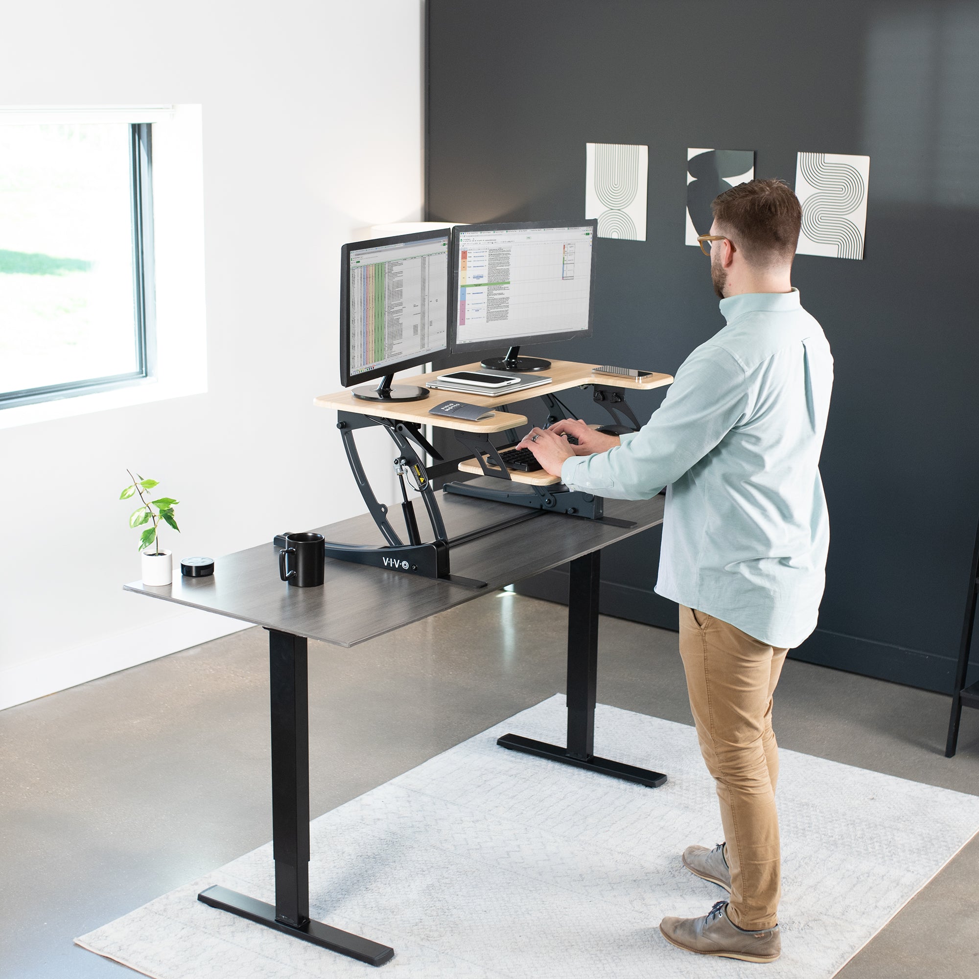 Heavy-duty height adjustable desk converter monitor riser with 2 tiers.