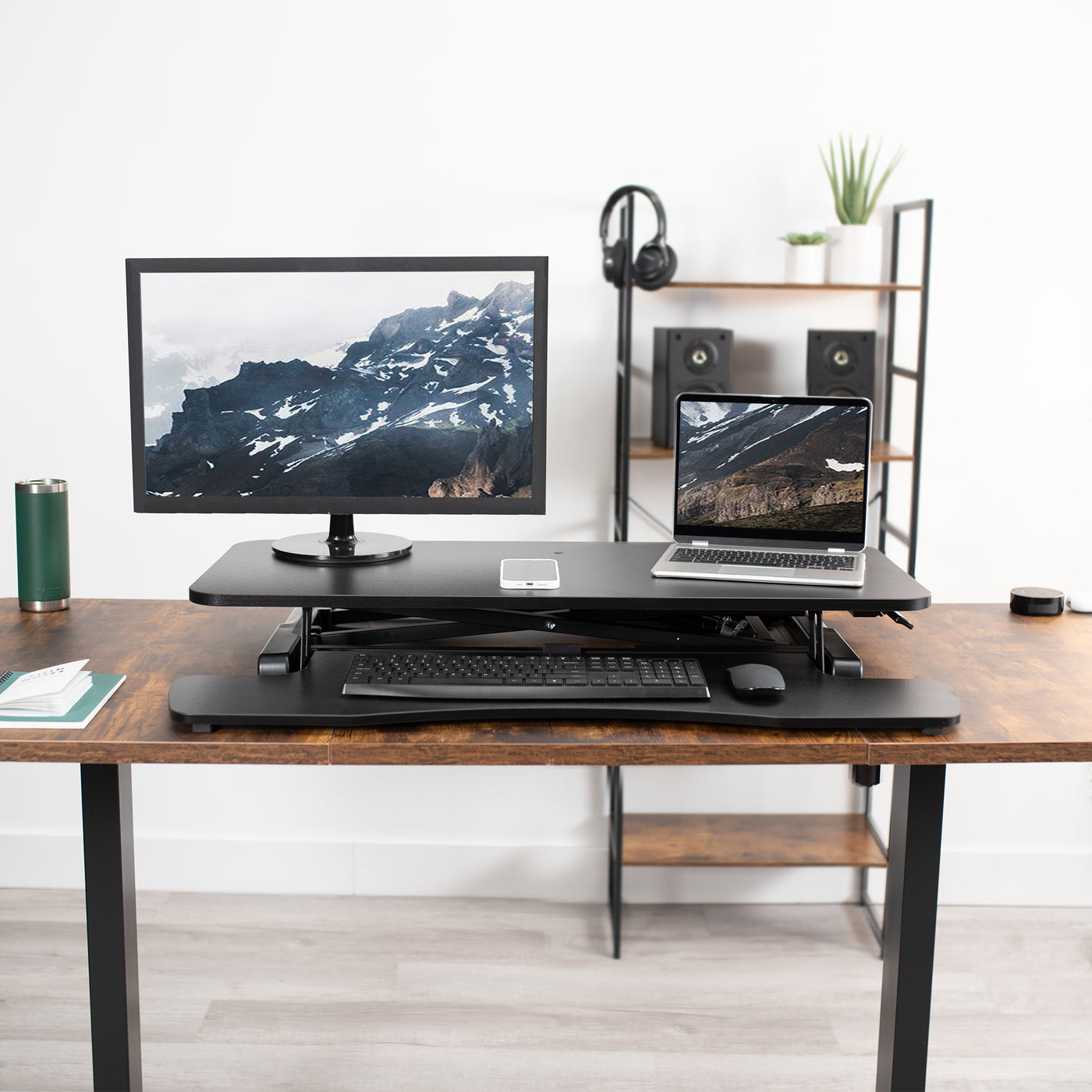 Lowered desk converter and desk top level for the convenience of working while sitting.