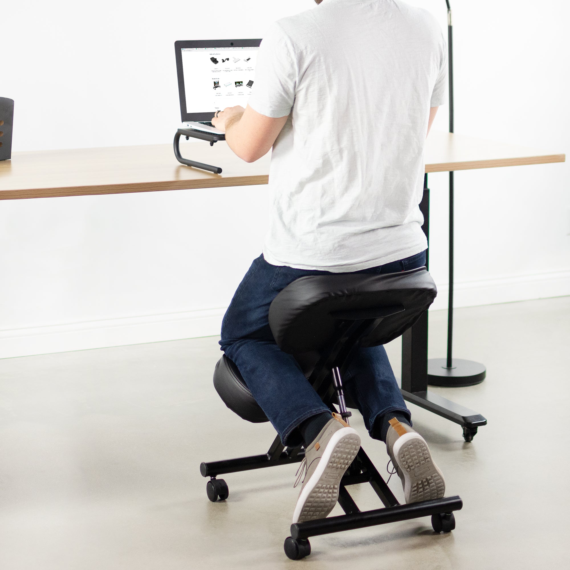 Back view of the kneeling chair while doing desk work.